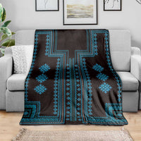 Traditional blue geometric blanket with dark background and central cross-like motif