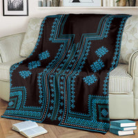 Traditional pattern blanket in dark fabric with vivid blue zigzag and diamond motifs