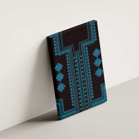 Blue canvas wall art with geometric cross motifs and teal border, angled view