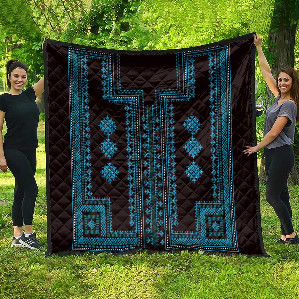 Dark quilt with blue geometric design panels and diamond motifs