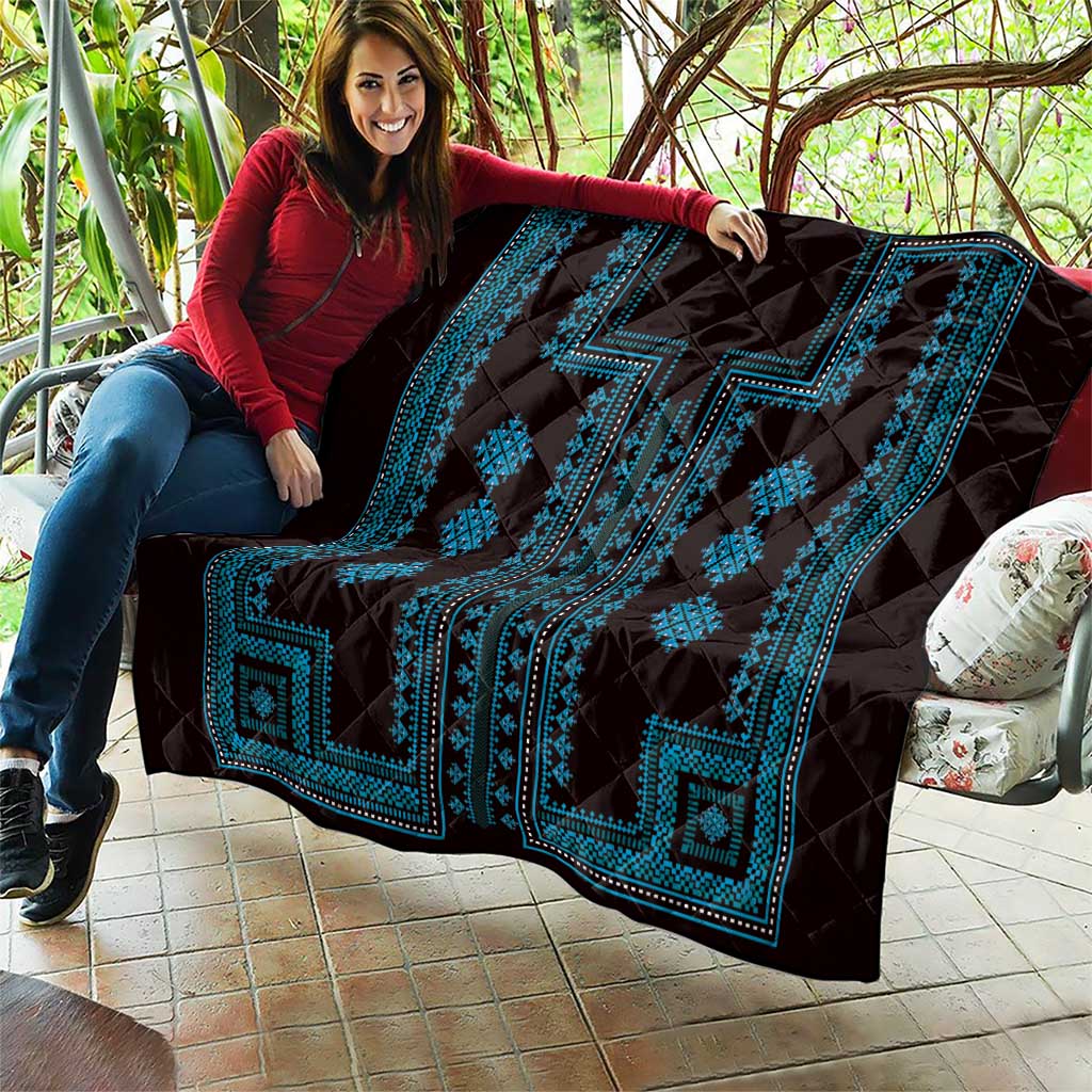 Black quilt throw with bright blue geometric band and diamond decorations