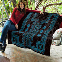 Black quilt throw with bright blue geometric band and diamond decorations