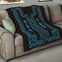 Dark quilt throw with bold blue geometric panel and border pattern