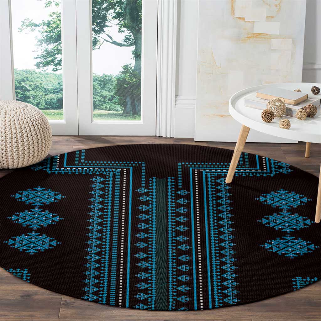 Round carpet with dark base and scattered blue geometric cross and diamond motifs