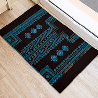 Corner view of black doormat with bright blue stripes, borders, and geometric icons