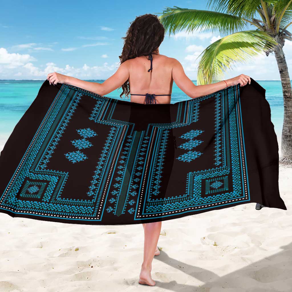 Blue geometric-pattern sarong on black base, wide wrap showing central emblem
