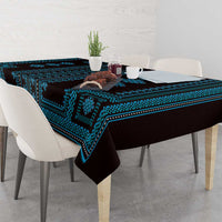 Blue and black patterned tablecloth draped on dining table