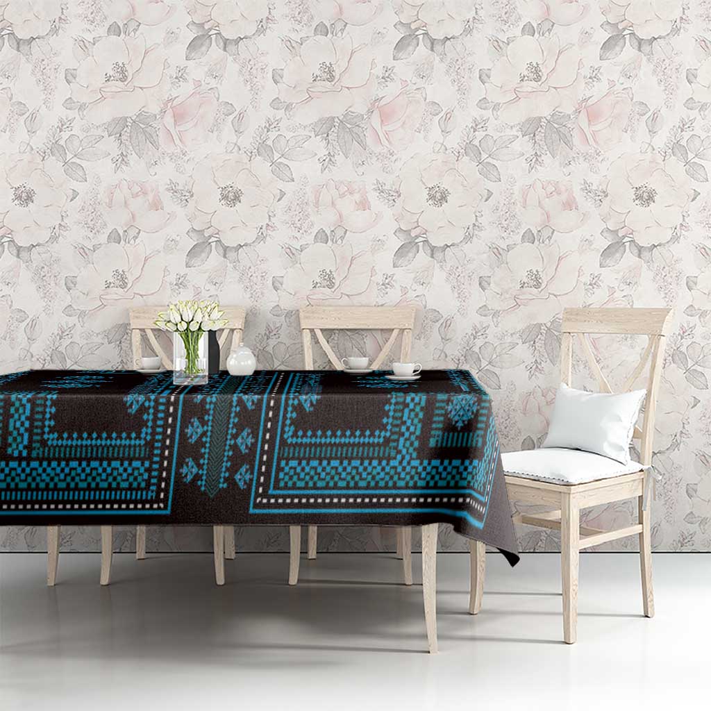 Blue and black geometric tablecloth with traditional border, spread on table