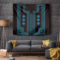 Traditional wall tapestry on brick wall above sofa, blue geometric motif on dark fabric