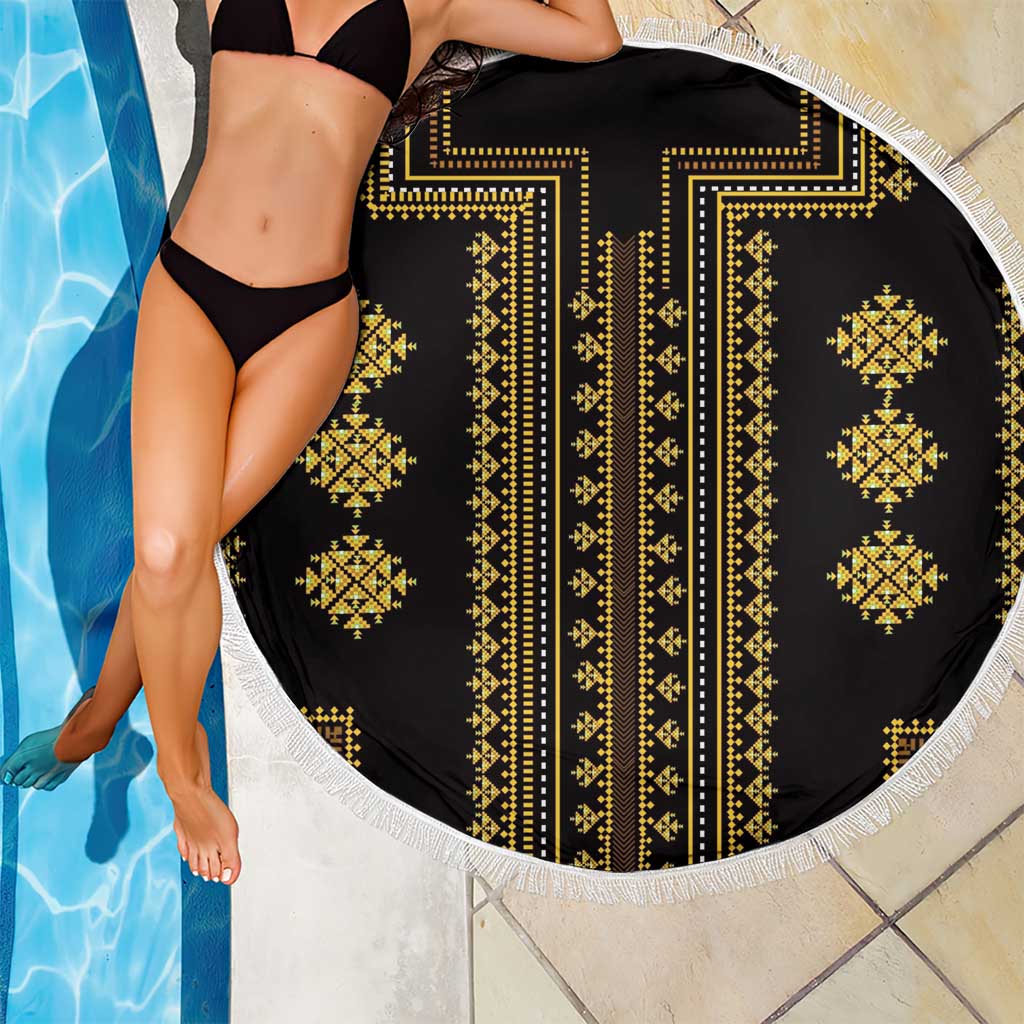 Round beach blanket draped with black base, gold geometric pattern, and white fringe