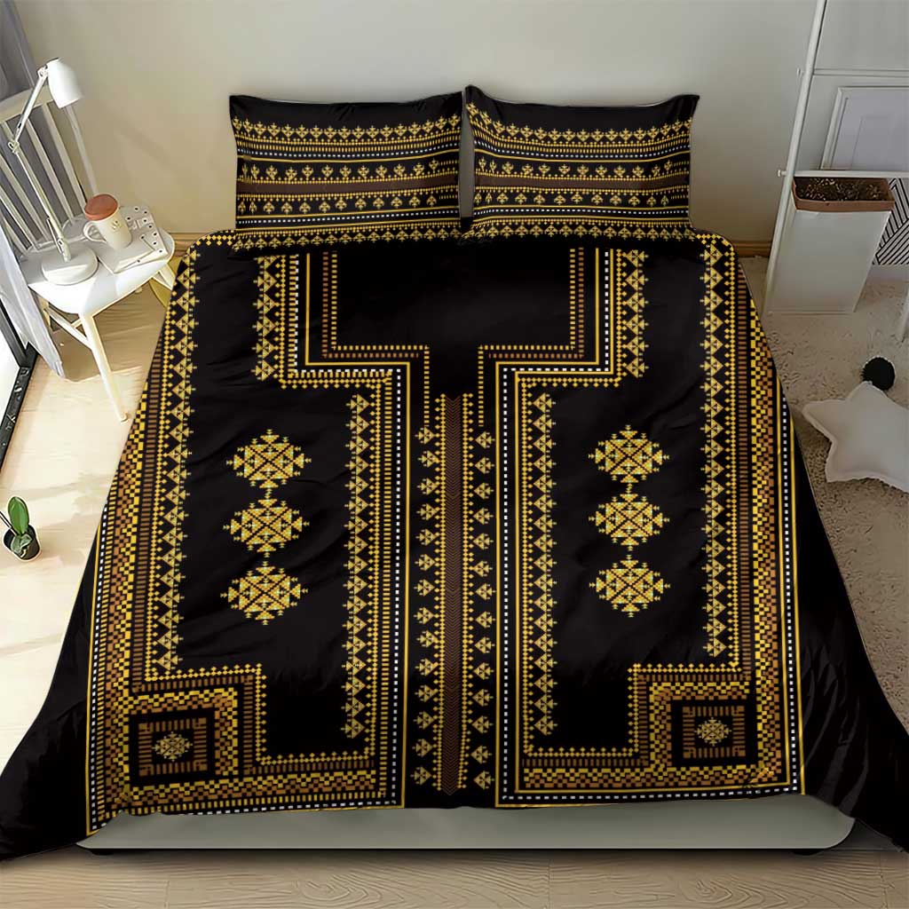 Black and gold patterned duvet cover with two pillow shams on a bed