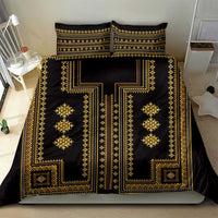 Black and gold patterned duvet cover with two pillow shams on a bed