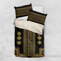 Black and gold bedding set flat lay: duvet cover and two matching pillow shams