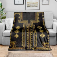 Dark blanket with gold geometric motifs and ornate center medallion
