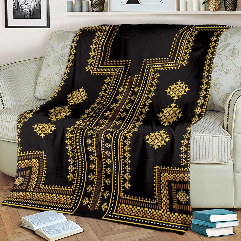 Dark throw blanket with gold patterned blocks and diamond ornaments