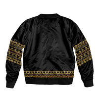 Black satin bomber jacket with gold geometric trim at cuffs, hem, and sleeves