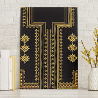 Black canvas wall art with gold geometric pattern, mounted against white brick wall