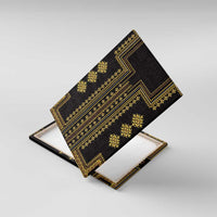 Black canvas wall art with gold geometric pattern, angled view on white backing