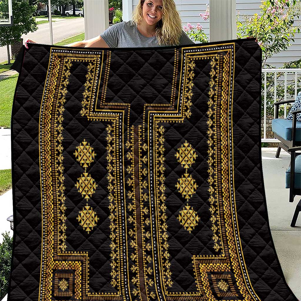 Black quilt with gold traditional geometric panels and diamond motifs, stitched in a quilted pattern.