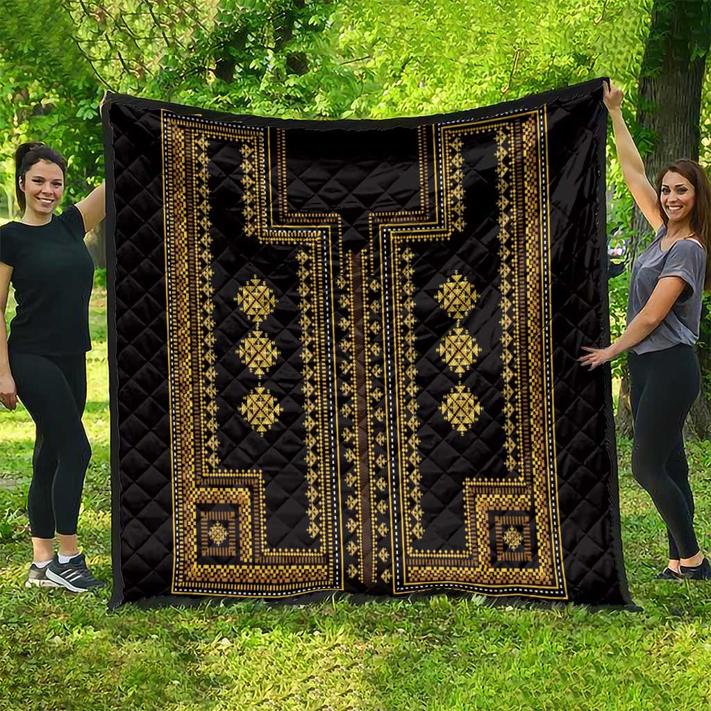 Black quilt blanket with gold Greek-key borders and diamond lattice motifs across the surface.