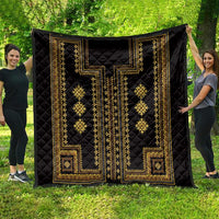 Black quilt blanket with gold Greek-key borders and diamond lattice motifs across the surface.