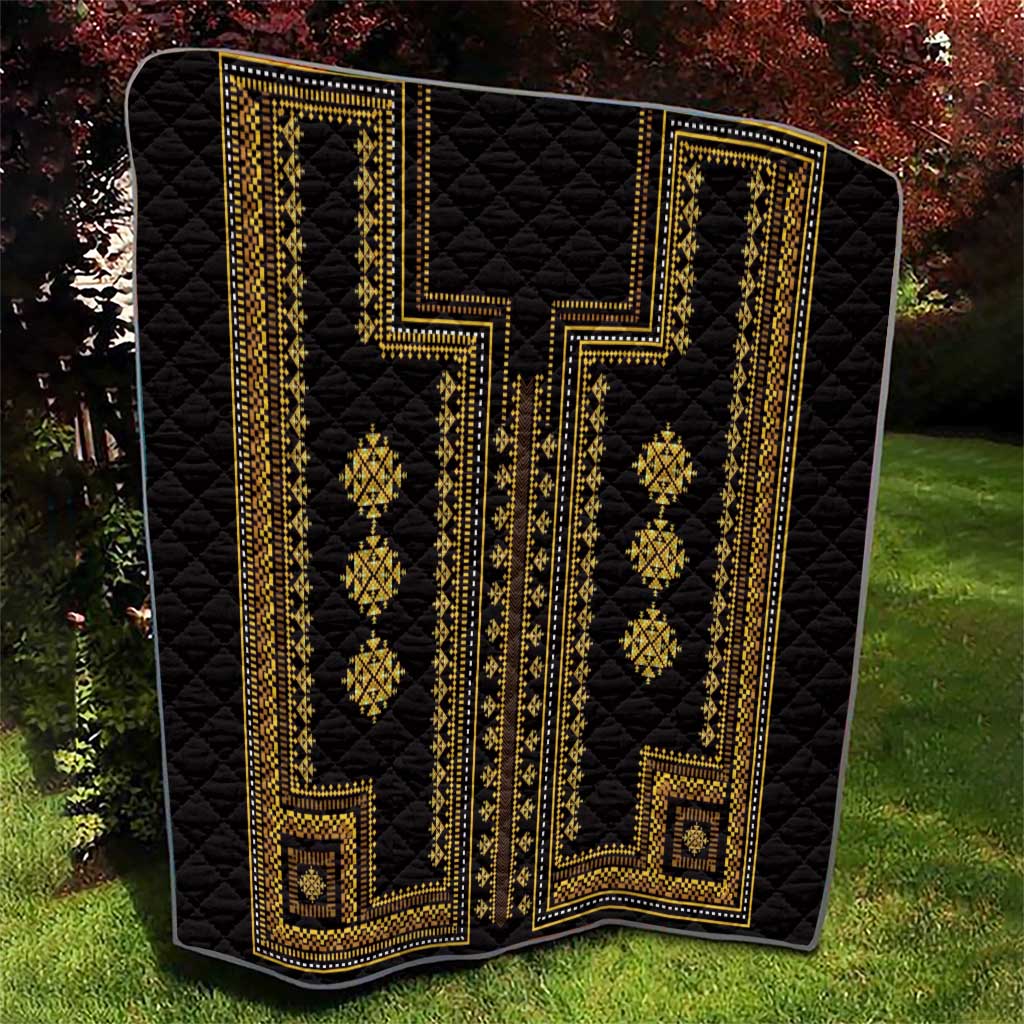 Black quilt throw with gold vertical bands, geometric diamonds, and decorative border details.