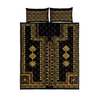 Black quilt and two gold geometric pillow shams with traditional border trim