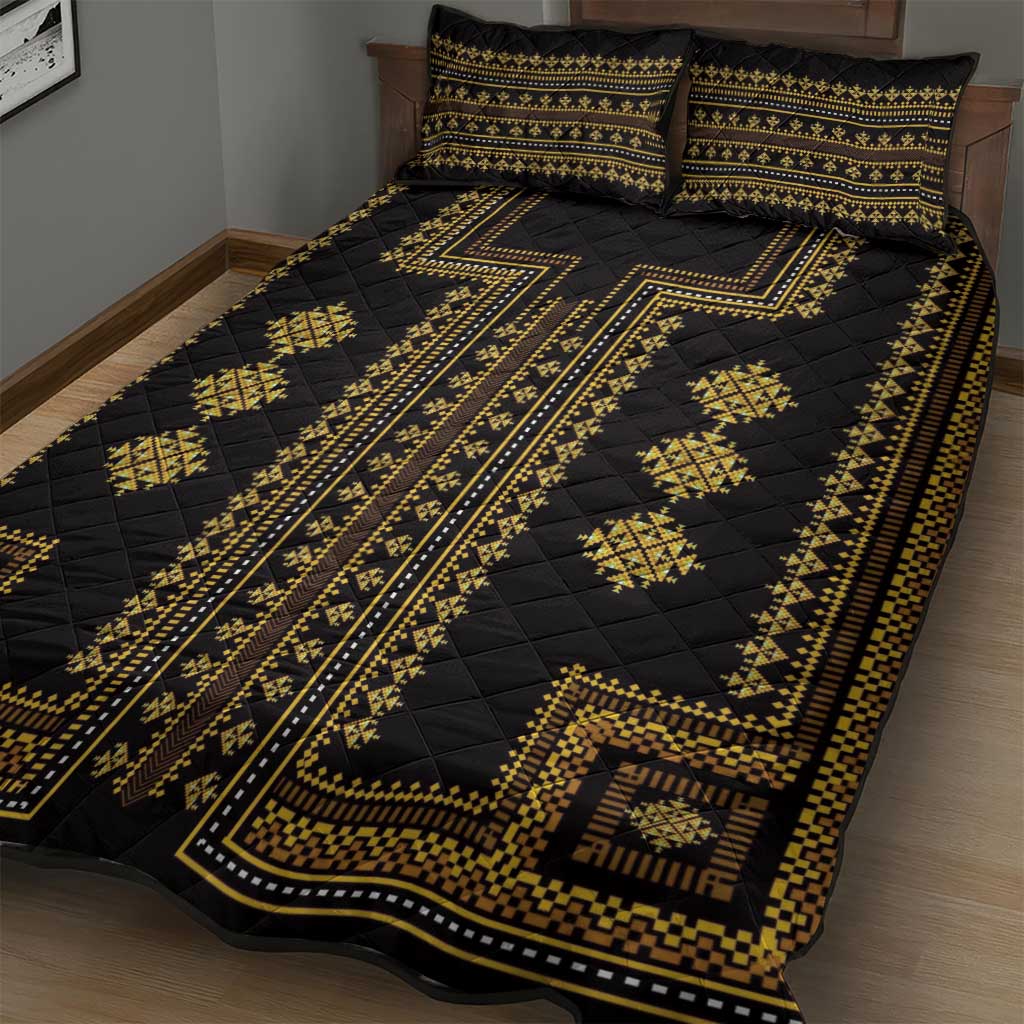 Black quilt with gold stripe and geometric motifs, paired with two pillow shams