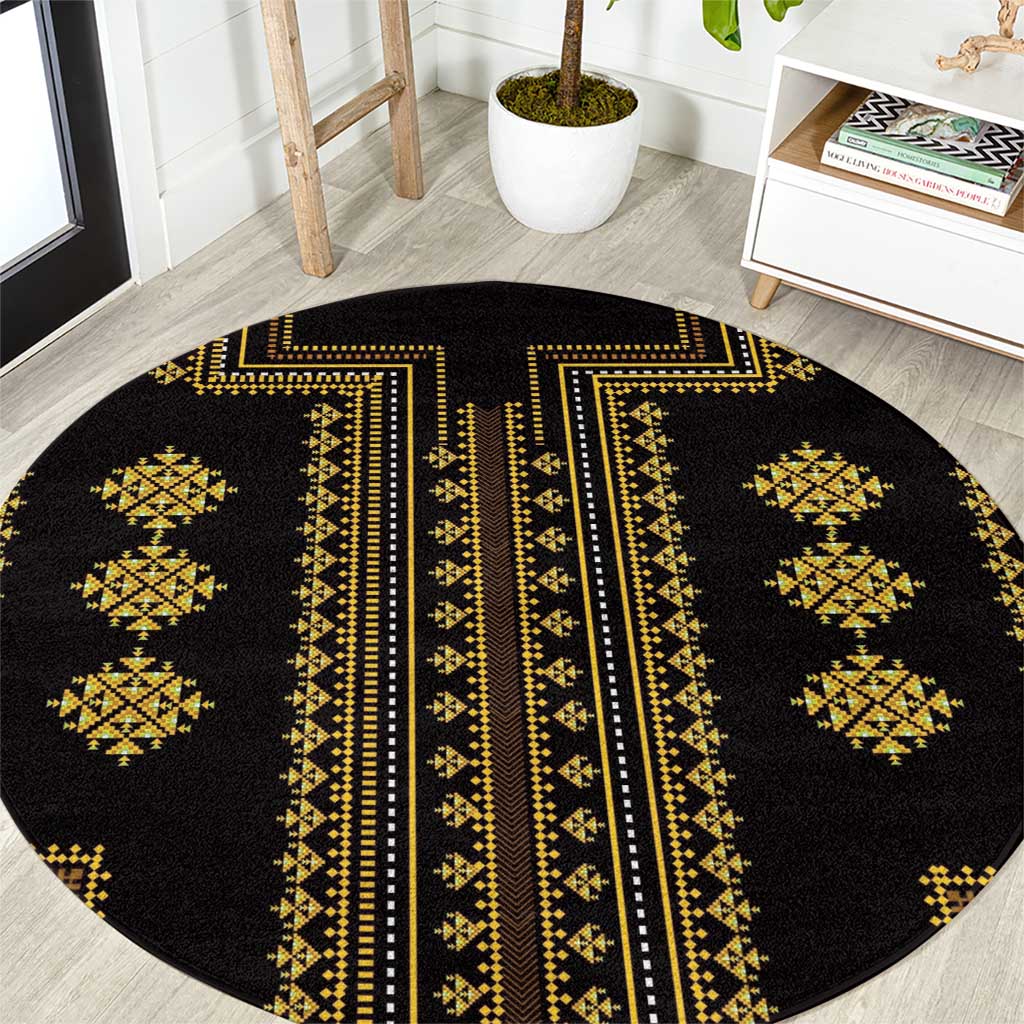 Round black rug with gold central stripe and repeating diamond geometric patterns.
