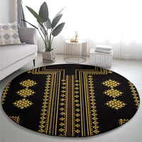 Round black rug with gold geometric pattern, central vertical stripes, and medallions.
