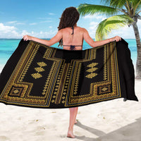 Black and gold geometric patterned sarong draped open in front view