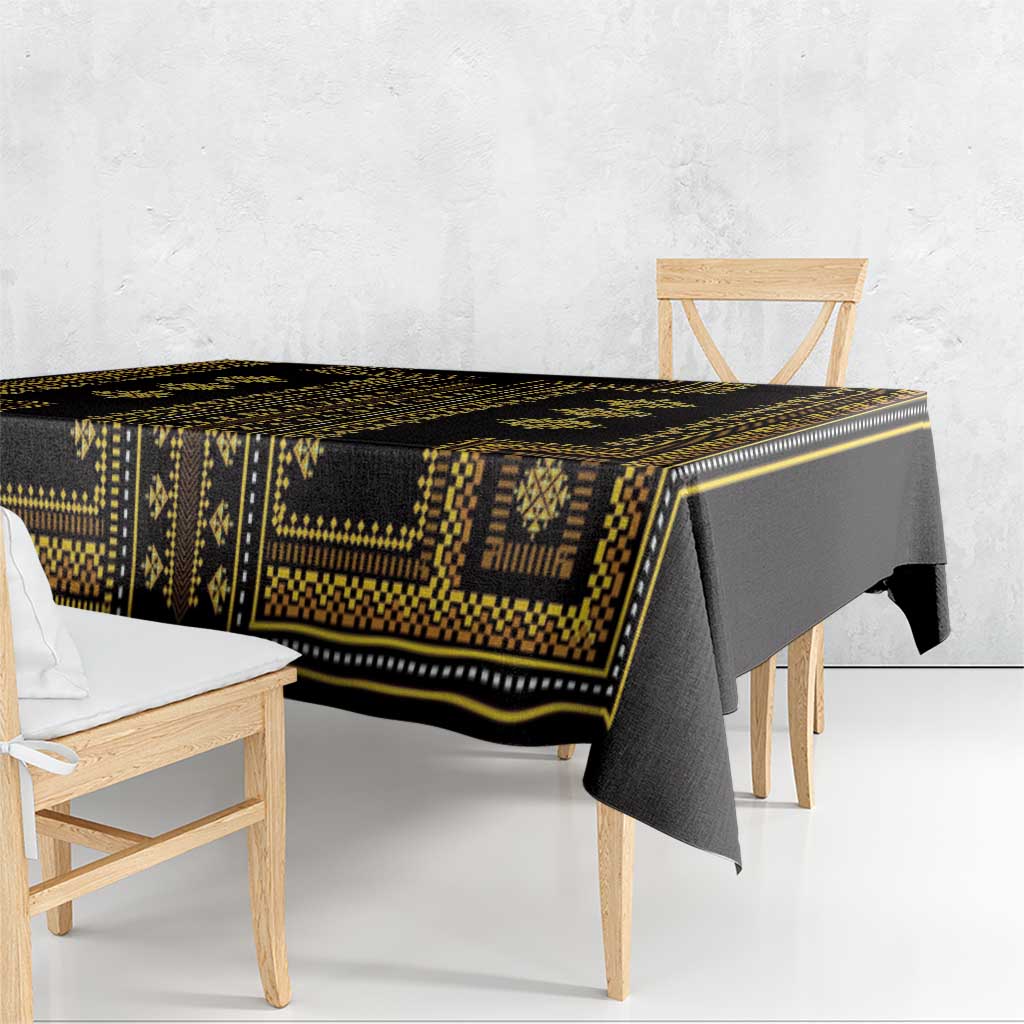 Dark tablecloth with gold geometric border, shown from the side edge