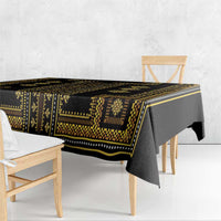 Dark tablecloth with gold geometric border, shown from the side edge