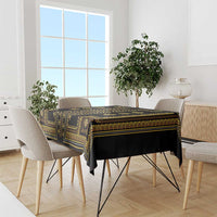 Dining table covered with dark tablecloth featuring gold geometric Balkan pattern