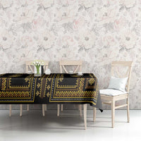 Tablecloth with dark base and gold patterned stripes, draped over dining table