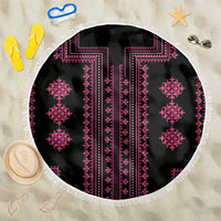 Round beach blanket with black base, pink geometric embroidery, and white fringe border