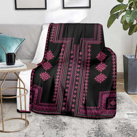 Black and pink patterned throw blanket draped over sofa, geometric accents