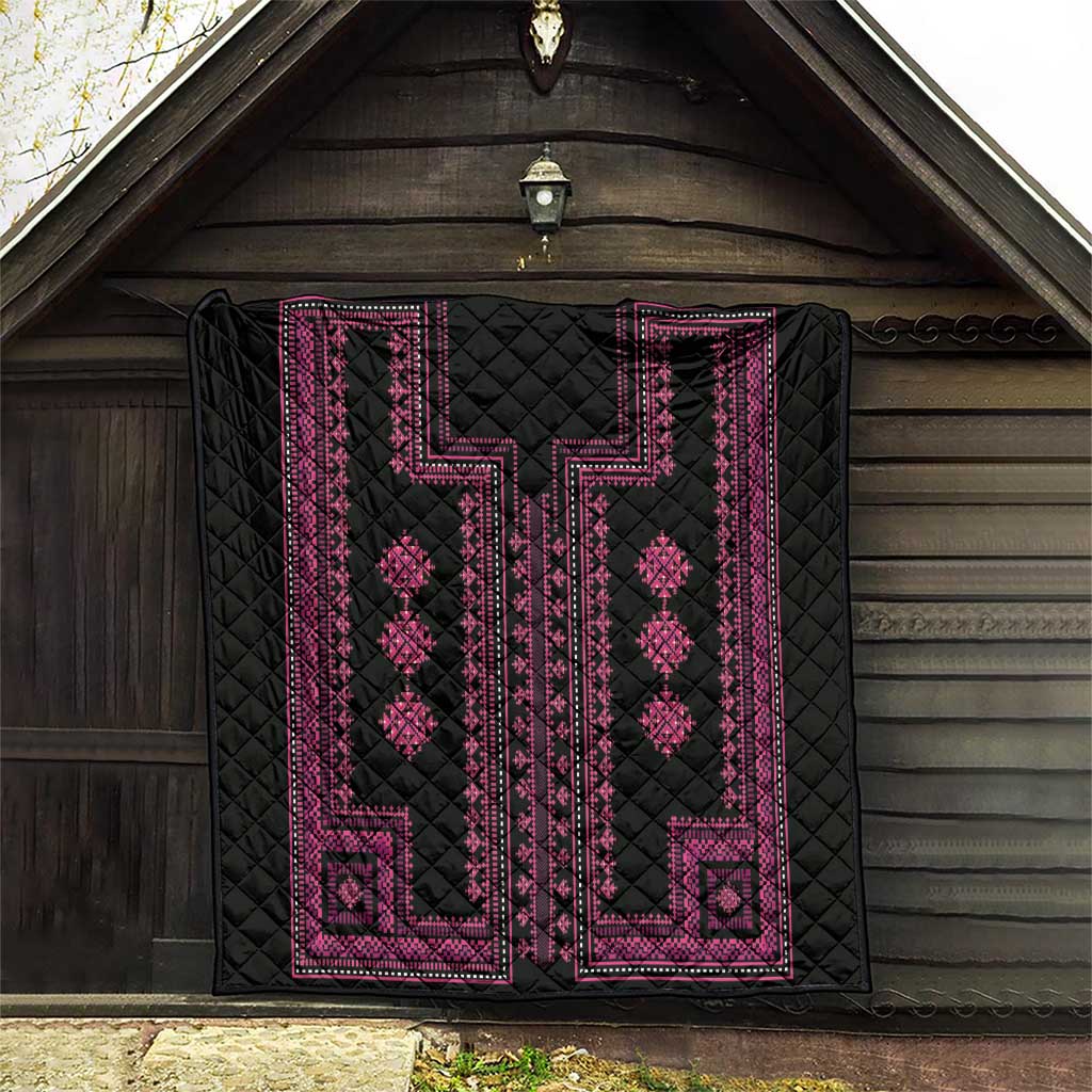 Quilted black blanket with pink traditional panel pattern, diamond motifs and border.