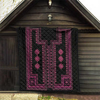 Quilted black blanket with pink traditional panel pattern, diamond motifs and border.