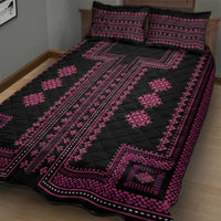 Black quilt with pink geometric border and diamond motifs, plus two pillow shams