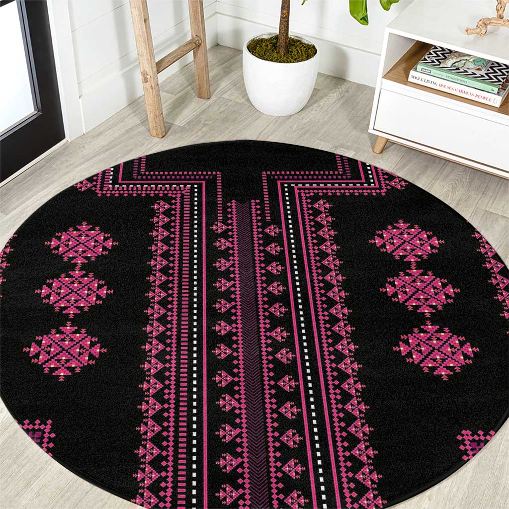 Round black rug featuring magenta vertical stripe center and diamond corner motifs