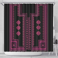 Black shower curtain with bright pink geometric Balkan-style pattern, top rings visible