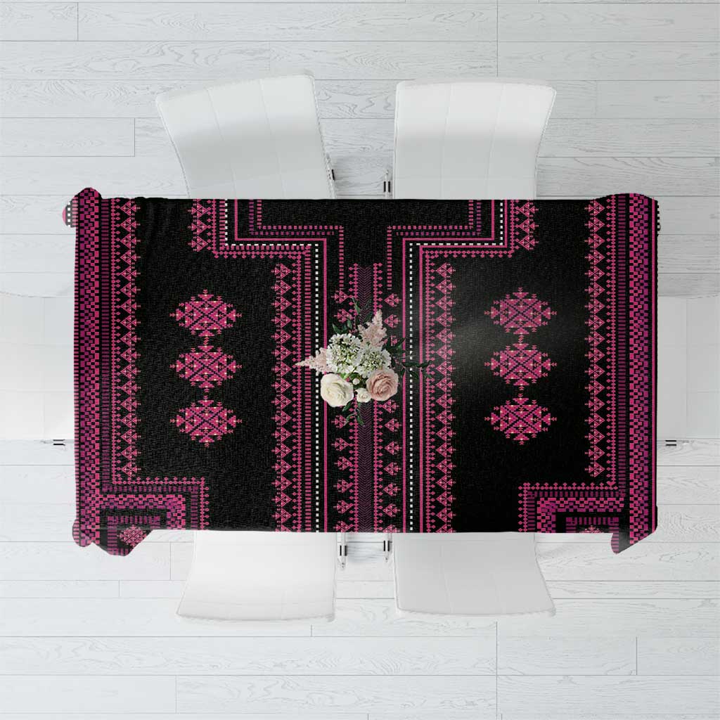 Flat-lay view of a black tablecloth with magenta geometric border pattern