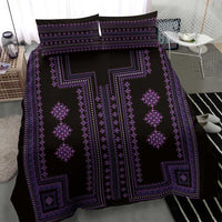 Close view of purple and black patterned duvet cover with geometric diamond motifs.