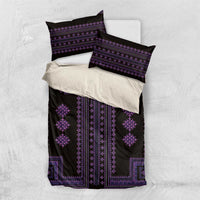 Purple and black patterned bedding set with two pillow covers on a light bedspread.