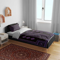 Purple-and-black patterned bedding set on a bed with matching pillow covers.