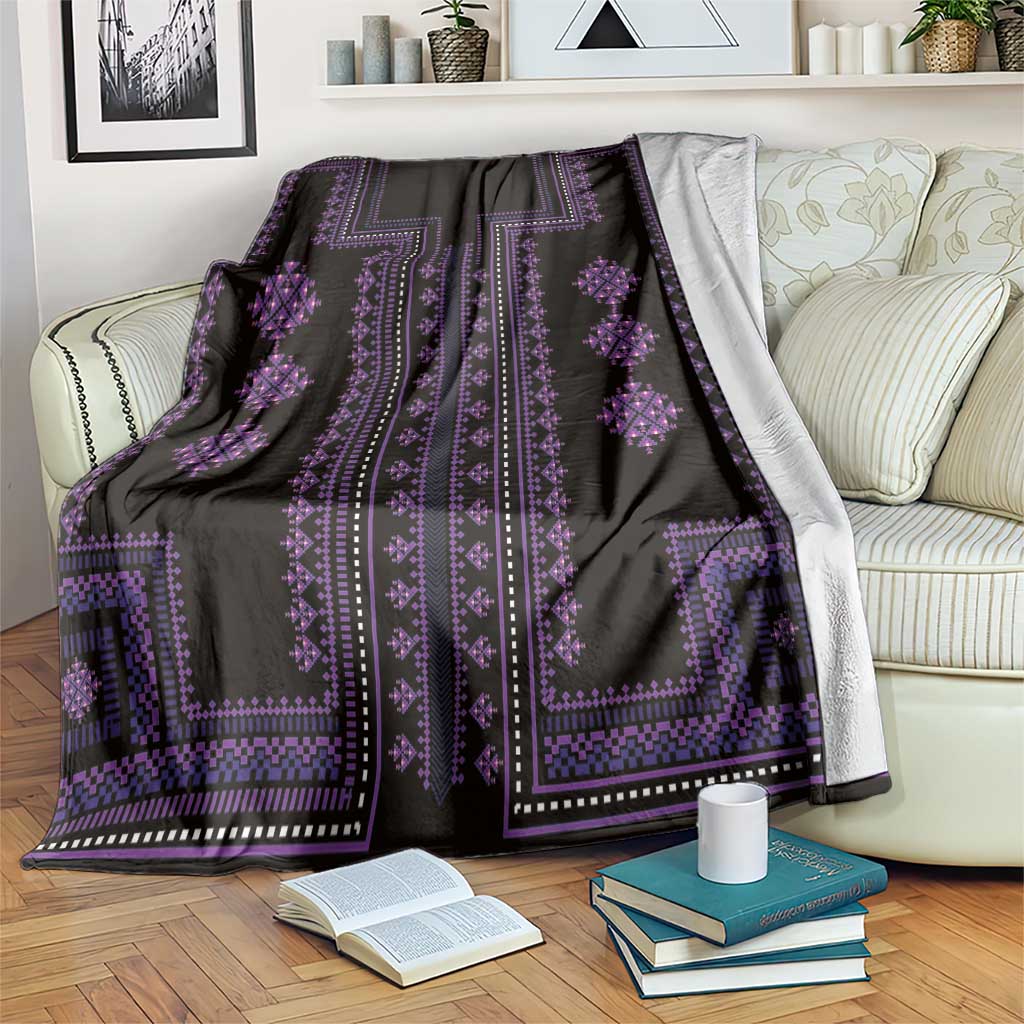 Black traditional pattern blanket with purple stripes and diamond ornaments draped on sofa