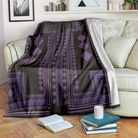 Black traditional pattern blanket with purple stripes and diamond ornaments draped on sofa