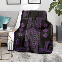Black and purple geometric pattern blanket draped over armchair, showing central stripe panel