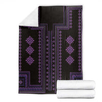 Black blanket with purple geometric border and diamond motifs, folded over neatly